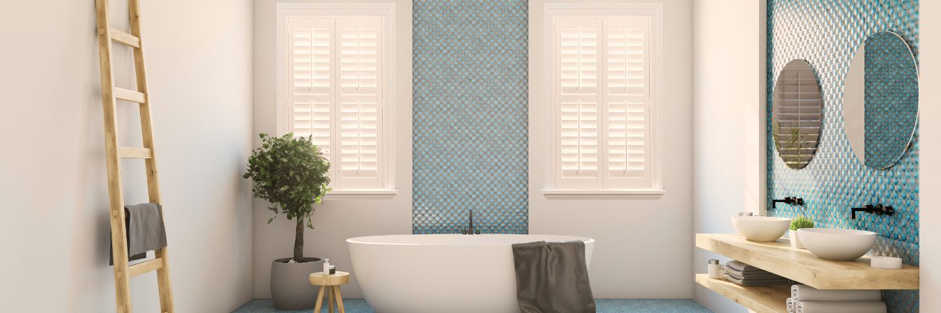 Modern bathroom with classic white plantation shutters.